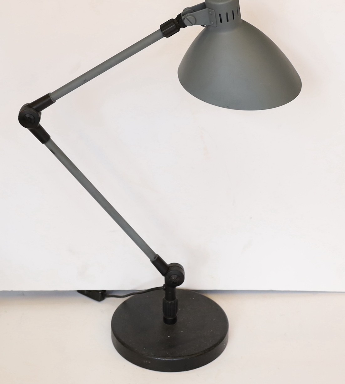 A 1950s Swiss enamelled and painted metal anglepoise lamp, height 56cm to the bend